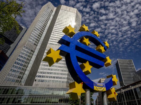 FILE - The Euro sculpture stands in front of the former European Central Bank in Frankfurt, Germany, on July 13, 2022. The euro has fallen below parity with the dollar, diving to its lowest level in 20 years and ending a one-to-one exchange rate with the U.S. currency. .(AP Photo/Michael Probst)