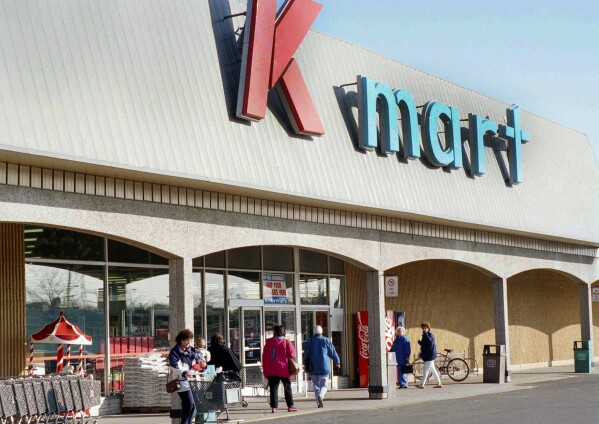 FILE - Kmart shoppers enter and leave the first Kmart ever built in Garden City, Mich., store, on Nov. 12, 1993. (AP Photo/Richard Sheinwald)