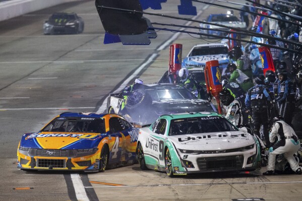 Driver Josh Berry (4) nearly makes contact with Chase Elliott (9) as he pulls out of his pit box during a NASCAR Cup Series auto race at Richmond Raceway on Sunday, March 31, 2024, in Richmond, Va. (AP Photo/Mike Caudill)