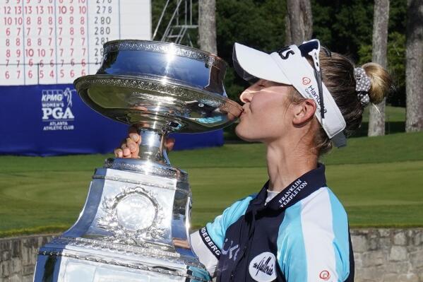 Nelly Korda of the U.S. kisses the trophy after winning the KPMG Women's PGA Championship golf tournament, Sunday, June 27, 2021, in Johns Creek, Ga. (AP Photo/John Bazemore)