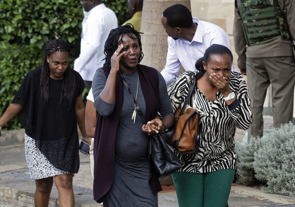 
              Civilians flee the scene at a hotel complex in Nairobi, Kenya Tuesday, Jan. 15, 2019. Terrorists attacked an upscale hotel complex in Kenya's capital Tuesday, sending people fleeing in panic as explosions and heavy gunfire reverberated through the neighborhood. (AP Photo/Ben Curtis)
            