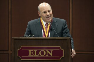 In this March 1, 2017 photo, Elon Trustee Louis DeJoy is honored with Elon's Medal for Entrepreneurial Leadership in Elon. N.C. DeJoy, a Republican fundraiser and prolific political donor from North Carolina, will be the next postmaster general. DeJoy of Greensboro, a close ally of President Donald Trump, was the unanimous pick of the U.S. Postal Service's Board of Governors, which made the announcement. 
(Kim Walker/Elon University via AP)