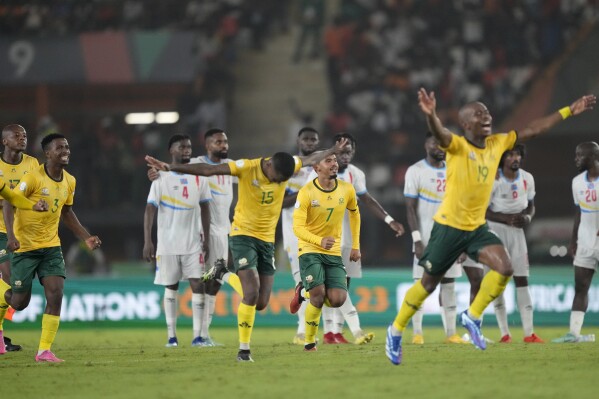 South Africa players celebrate winning the penalty shootout during the African Cup of Nations third place soccer match between South Africa and DR Congo, at the Felix Houphouet-Boigny in Abidjan, Ivory Coast, Saturday, Feb. 10, 2024. (AP Photo/Sunday Alamba)