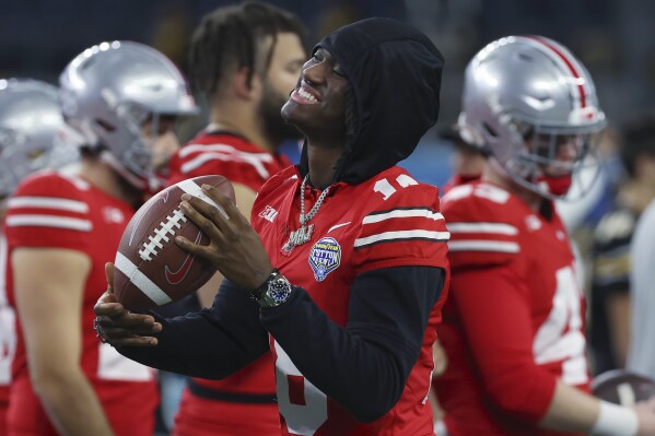 Ohio State wide receiver Marvin Harrison Jr. smiles before the team's Cotton Bowl NCAA college football game against Missouri on Friday, Dec. 29, 2023, in Arlington, Texas. (AP Photo/Richard W. Rodriguez)