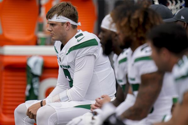 FILE - New York Jets quarterback Zach Wilson sits on the bench during the first half of an NFL football game against the Tennessee Titans, Sunday, Oct. 3, 2021, in East Rutherford. Zach Wilson has been benched by the New York Jets and will be replaced by Mike White as the starter Sunday against the Chicago Bears. Coach Robert Saleh announced the decision Wednesday, Nov. 23, after evaluating and discussing the situation with his assistants. (AP Photo/Seth Wenig, File)