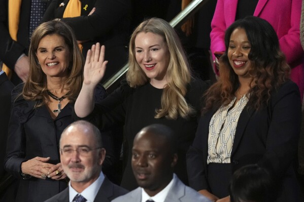 Maria Shriver, left, Kate Cox, of Dallas and Latorya Beasley of Birmingham, Ala., stand before President Joe Biden delivers the State of the Union address to a joint session of Congress at the U.S. Capitol, Thursday March 7, 2024, in Washington. In front are United Auto Workers President Shawn Fain and Keenan Jones of Plymouth, Minn.. (AP Photo/Andrew Harnik)