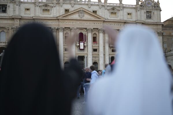 Nuns react during the speech of the newly elected Pope Leo XIV at the Vatican, Thursday, May 8, 2025. (AP Photo/Francisco Seco)