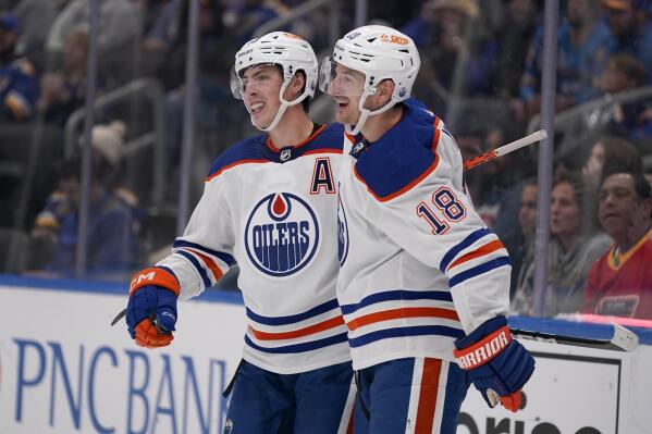 Edmonton Oilers' Ryan Nugent-Hopkins, left, is congratulated by Zach Hyman (18) after scoring during the third period of an NHL hockey game against the St. Louis Blues Wednesday, Oct. 26, 2022, in St. Louis. (AP Photo/Jeff Roberson)