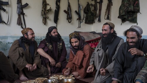 Taliban fighters enjoy lunch inside an adobe house that is used as a makeshift checkpoint in Wardak province, Afghanistan, Thursday June 22, 2023. (AP Photo/Rodrigo Abd)