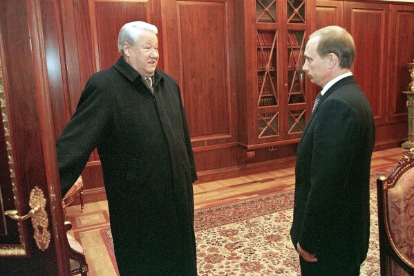FILE - Former President Boris Yeltsin, left, smiles as he talks to Russian acting President and Premier Vladimir Putin at the Kremlin in Russia, Dec. 31, 1999. (Sputnik, Kremlin Pool Photo via AP, File)