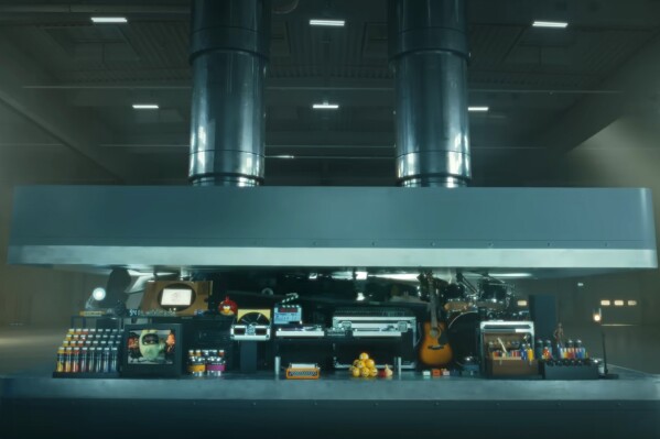 In this image taken from a video advertisement, a hydraulic press crushes an array of creative instruments .The newly-released ad promoting Apple's new iPad Pro has struck quite a nerve online. (Apple via AP)