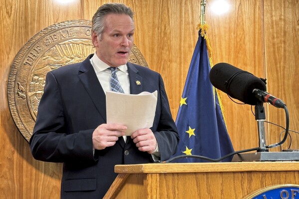 FILE - Alaska Republican Gov. Mike Dunleavy speaks to reporters during a news conference on topics including education on Wednesday, Feb. 7, 2024, in Juneau, Alaska. Dunleavy has vetoed an education funding package overwhelming passed by lawmakers and urged action on teacher bonus and charter school provisions that have been divisive among legislators. The Republican governor announced his decision hours ahead of a deadline he faced to sign the bill, veto it or let it become law without his signature. (AP Photo/Becky Bohrer, File)