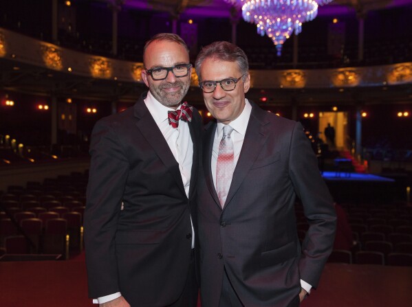 This image released by Opera Philadelphia shows David B. Devan, General Director and President of Opera Philadelphia, left, and Music Director Corrado Rovaris, at the Festival O19 Celebration on Sept. 21, 2019, in Philadelphia. Devan will retire next spring as head of Opera Philadelphia following 13 years as general director and has postponed one of this season’s productions to balance the company’s budget. Rovaris was given a three-year contract extension through 2026-27. (Sofia Negron/Opera Philadelphia via AP)