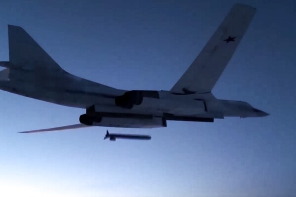FILE - In this photo taken from a video distributed by Russian Defense Ministry Press Service, on Dec. 9, 2020, a Russian Tu-160 strategic bomber fires a cruise missile at test targets, during a military drills, Russia. The Russian Defense Ministry said that the military will hold drills involving tactical nuclear weapons – the first time such exercise was publicly announced by Moscow. (Russian Defense Ministry Press Service via AP, File)