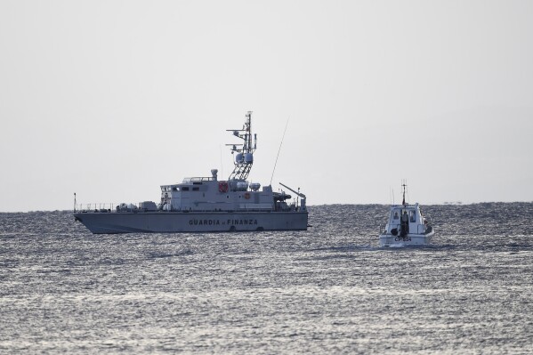 Emergency services at the scene of the search for a missing boat, in Porticello, southern Italy, Tuesday, Aug. 20, 2024. Rescue teams and divers returned to the site of a storm-sunken superyacht Tuesday to search for six people, including British tech magnate Mike Lynch, who are believed to be still trapped in the hull 50 meters (164-feet) underwater. (AP Photo/Salvatore Cavalli)