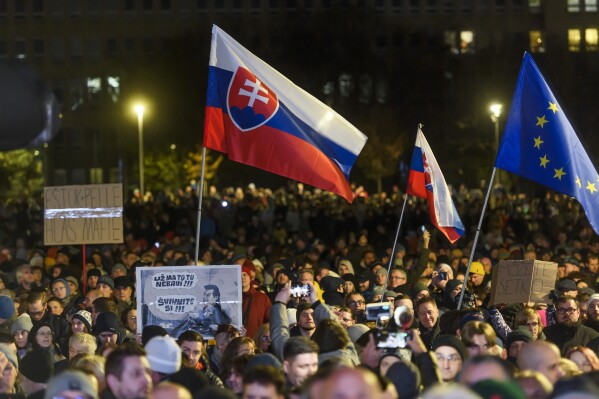 People take part in a protest against scrapping the Special Prosecutor's Office organised by the Slovakian opposition parties in front of the Government Office in Bratislava, Tuesday, Dec. 12, 2023. (Lukas Grinaj/TASR via AP)