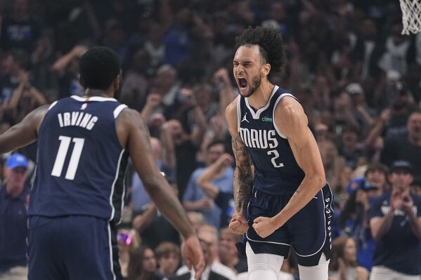 Dallas Mavericks center Dereck Lively II (2) celebrates after scoring against the Minnesota Timberwolves during the first half in Game 3 of the NBA basketball Western Conference finals, Sunday, May 26, 2024, in Dallas. (AP Photo/Julio Cortez)