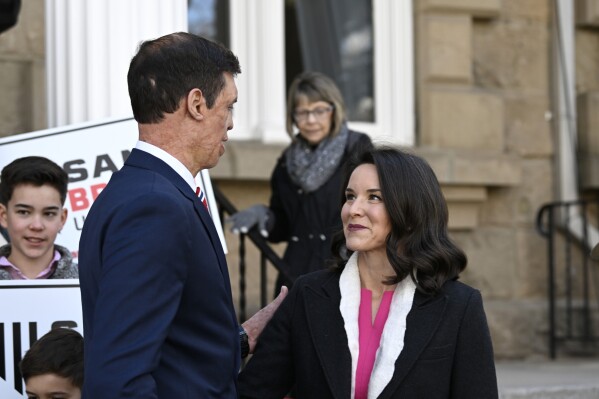 Republican U.S. Senatorial candidate Sam Brown joins his wife Amy Brown after speaking to a small group of supporters and media after filing his paperwork to run for the Senate, Thursday, March 14, 2024, at the State Capitol in Carson City, Nev. Brown is seeking to replace incumbent U.S. Sen. Jacky Rosen. (AP Photo/Andy Barron)