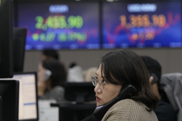 A currency trader watches monitors at the foreign exchange dealing room of the KEB Hana Bank headquarters in Seoul, South Korea, Wednesday, Oct. 18, 2023. (AP Photo/Ahn Young-joon)