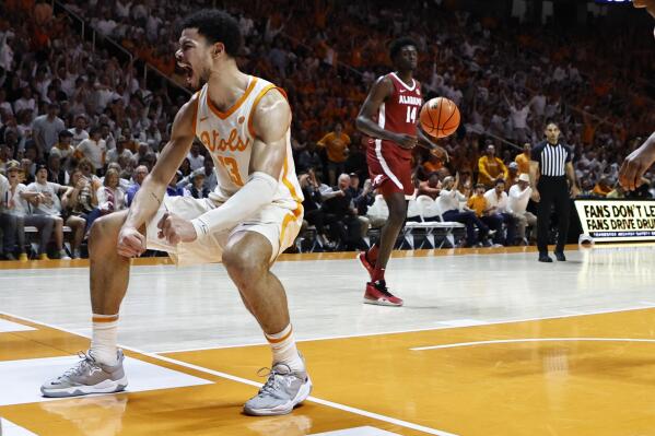 Tennessee forward Olivier Nkamhoua (13) reacts to dunking the ball during the first half of an NCAA college basketball game against Alabama, Wednesday, Feb. 15, 2023, in Knoxville, Tenn. (AP Photo/Wade Payne)