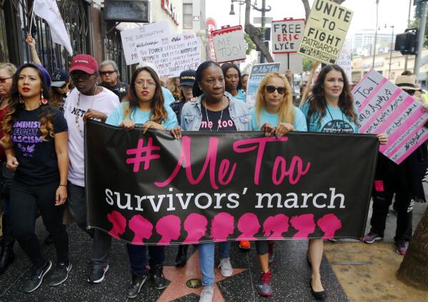FILE - In this Nov. 1, 2017 file photo, participants march against sexual assault and harassment during the #MeToo March in the Hollywood section of Los Angeles. At center is Tarana Burke, founder of the #MeToo movement. According to a 2021 The Associated Press-NORC Center for Public Affairs Research poll, just over half of Americans - 54% - say they personally are more likely to speak out if they're a victim of sexual misconduct. (AP Photo/Damian Dovarganes, File)