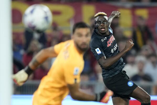 Napoli's Victor Osimhen, right, scores his side's opening goal during a Serie A soccer match between Roma and Napoli, at the Olimpic stadium in Rome, Sunday, Oct. 23, 2022. (AP Photo/Andrew Medichini)