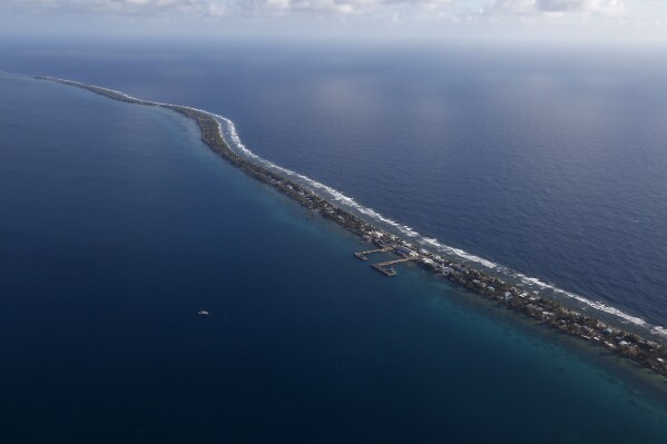FILE - Funafuti, the main island nation state Tuvalu, is seen from a Royal New Zealand airforce C130 aircraft as it approaches at Funafuti, Tuvalu, South Pacific, on Oct. 13, 2011. Voting started Friday, Jan. 26, 2024, in the tiny Pacific island nation of Tuvalu, in a national election that could reverberate from China to Australia. (AP Photo/Alastair Grant, File)