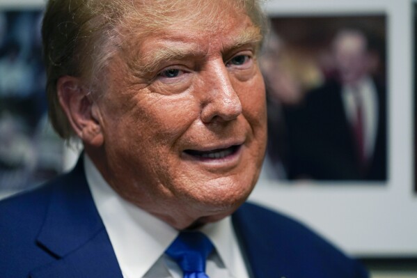 Republican presidential candidate former President Donald Trump talks as he signs papers to be on the 2024 Republican presidential primary ballot at the New Hampshire Statehouse, Monday, Oct. 23, 2023, in Concord, N.H. (AP Photo/Charles Krupa)