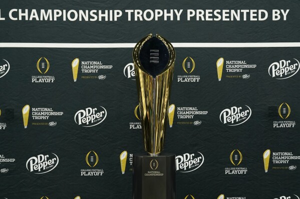 The trophy is displays during media day ahead of the national championship NCAA College Football Playoff game between Washington and Michigan Saturday, Jan. 6, 2024, in Houston. The game will played Monday. (AP Photo/Godofredo A. Vasquez)