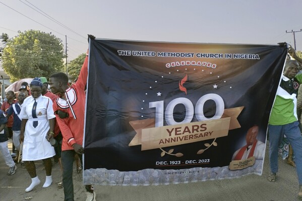 United Methodist church members carry a banner during a rally in Jalingo, Nigeria, celebrating the 100th anniversary of Methodism in the country, in December 2023. Despite the celebration, church leaders in Nigeria are considering leaving the United Methodist Church over differences on ordination of LGBTQ people and same-sex marriage. (Ezekiel Ibrahim Maisamari/UM News via AP)