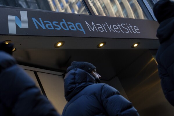 People walk past the Nasdaq MarketSite, Monday, Jan. 27, 2025, in New York. (AP Photo/Julia Demaree Nikhinson, File)