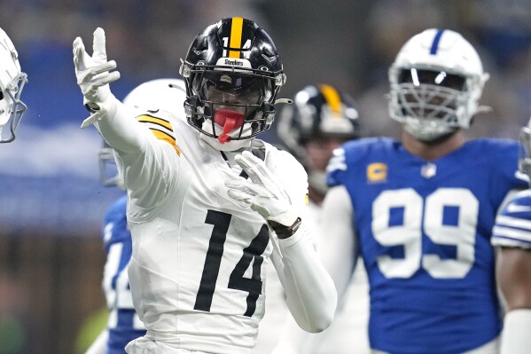 Pittsburgh Steelers wide receiver George Pickens (14) celebrates after getting a first down during the first half of an NFL football game against the Indianapolis Colts in Indianapolis Saturday, Dec. 16, 2023. (AP Photo/Michael Conroy)