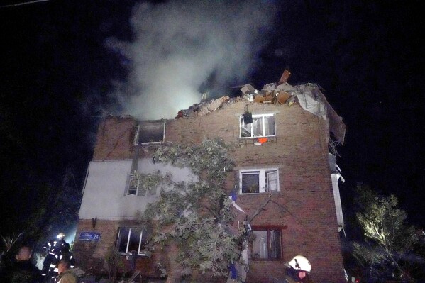 Firefighters put out a fire an apartment building damaged in the Russian missile attack in Kharkiv, Ukraine, Friday, May, 31, 2024. (AP Photo/Andrii Marienko)