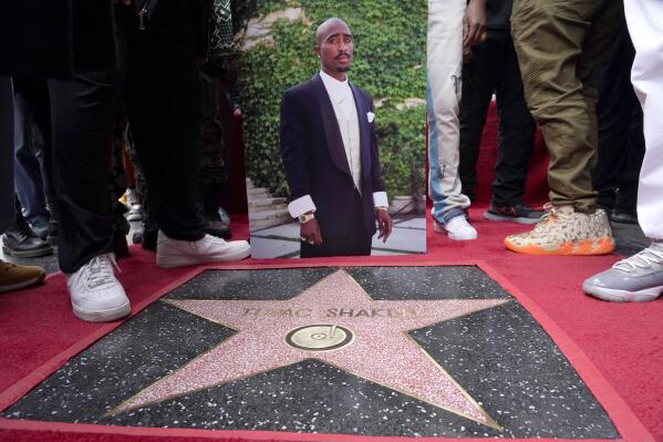 An image of the late rapper/actor Tupac Shakur appears near his new star on the Hollywood Walk of Fame during a posthumous ceremony in his honor on Wednesday, June 7, 2023, in Los Angeles. (AP Photo/Chris Pizzello)