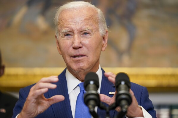 President Joe Biden, center, delivers remarks on recovery efforts for the Maui wildfires and the response to Hurricane Idalia, in the Roosevelt Room of the White House, Wednesday, Aug. 30, 2023, in Washington. (AP Photo/Evan Vucci)