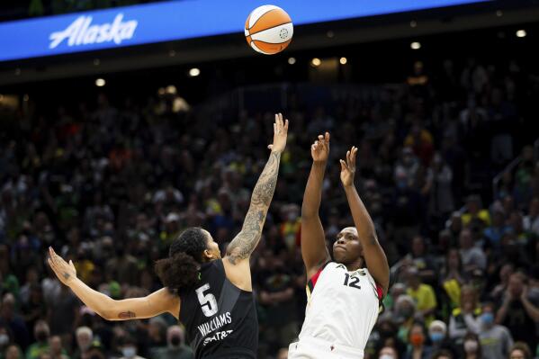 Las Vegas Aces guard Chelsea Gray (12) shoots over Seattle Storm forward Gabby Williams (5) during the first half in Game 3 of a WNBA basketball semifinal playoff series Sunday, Sept. 4, 2022, in Seattle. (AP Photo/Lindsey Wasson)