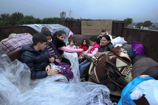 FILE - Ethnic Armenians from Nagorno-Karabakh sit in a truck on their way to Kornidzor in Syunik region, Armenia, Sept. 25, 2023. Thousands of Armenians have streamed out of Nagorno-Karabakh after the Azerbaijani military reclaimed full control of the breakaway region last week. (Stepan Poghosyan, Photolure photo via AP, File)