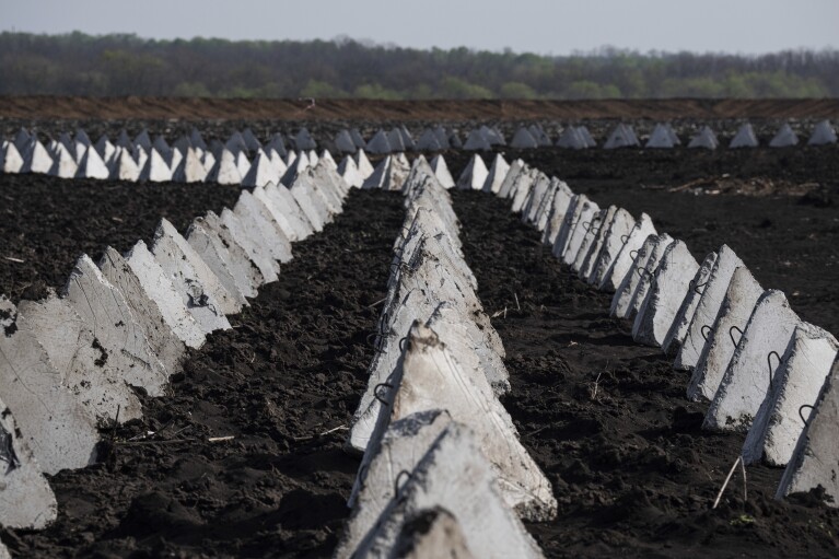 Anti-tank systems known as “dragon teeth” are seen in the field close to the Russian border in the Kharkiv region, Ukraine, on Wednesday, April 17, 2024. (AP Photo/Evgeniy Maloletka)