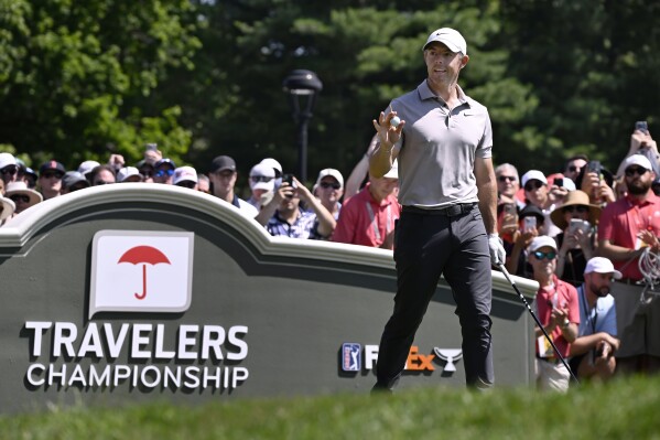 Rory McIlroy of Northern Ireland, waves as he is announced at the first tee during the first round of the Travelers Championship golf tournament at TPC River Highlands, Thursday, June 19, 2025, in Cromwell, Conn. (AP Photo/Jessica Hill)