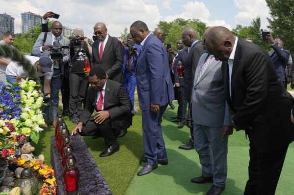From right, South African President Cyril Ramaphosa, President of the Union of Comoros Azali Assoumani, Senegal's President Macky Sall, and Zambia's President Hakainde Hichilema, bottom, attend a commemoration ceremony at a site of a mass grave in Bucha, on the outskirts of Kyiv, Ukraine, Friday, June 16, 2023. South African President Cyril Ramaphosa arrived in Ukraine on Friday as part of a delegation of African leaders and senior officials seeking ways to end Kyiv's 15-month war with Russia. (AP Photo/Efrem Lukatsky)