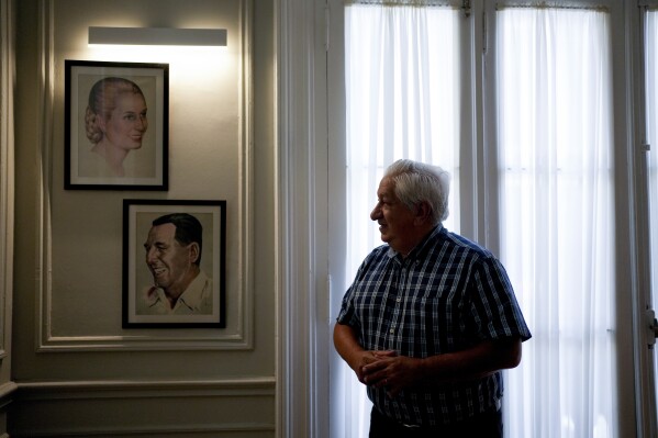Julio Piumato, human rights director of the General Confederation of Labor, poses next to framed portraits of the late President Juan Domingo Peron and former first lady María Eva Duarte de Perón, better known as Eva Perón, or Evita, in his union office, in Buenos Aires, Argentina, Wednesday, Jan. 24, 2024. “For us, she is the spiritual reservoir of the people,” said Piumato of Evita. (AP Photo/Natacha Pisarenko)