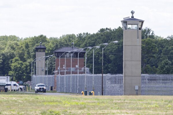 Office patrol the grounds of the federal prison in Terre Haute, Ind., is shown Monday, July 13, 2020. Daniel Lewis Lee, a convicted killer, was scheduled to be executed at 4 p.m. He was convicted in Arkansas of the 1996 killings of gun dealer William Mueller, his wife, Nancy, and her 8-year-old daughter, Sarah Powell. (AP Photo/Michael Conroy)