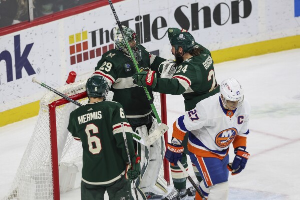 Minnesota Wild defenseman Zach Bogosian celebrates with goaltender Marc-Andre Fleury after winning against the New York Islanders following an NHL hockey game, Monday, Jan. 15, 2024, in St. Paul, Minn. (AP Photo/Stacy Bengs)