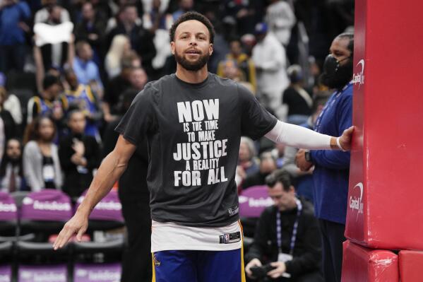 Golden State Warriors guard Stephen Curry (30) warms up in a shirt honoring Martin Luther King Jr. before an NBA basketball game against the Washington Wizards, Monday, Jan. 16, 2023, in Washington. (AP Photo/Jess Rapfogel)