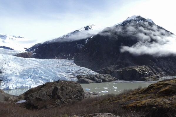 FILE - Chunks of ice float in Mendenhall Lake in front of the Mendenhall Glacier on April 29, 2023, in Juneau, Alaska. An Alaska man inadvertently filmed his own drowning on the glacial lake with a GoPro camera mounted on his helmet, but authorities who recovered the camera have not yet found his body, officials said Tuesday, July 18, 2023. (AP Photo/Becky Bohrer, File)
