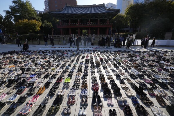About 2,000 pairs of shoes symbolizing all the victims from Gaza, West Bank and Israel are placed before a rally in Seoul, South Korea, Friday, Nov. 17, 2023. About 2,000 pairs of shoes are donated by people who stands in solidarity and placed by members of civic groups in downtown Seoul.(AP Photo/Lee Jin-man)