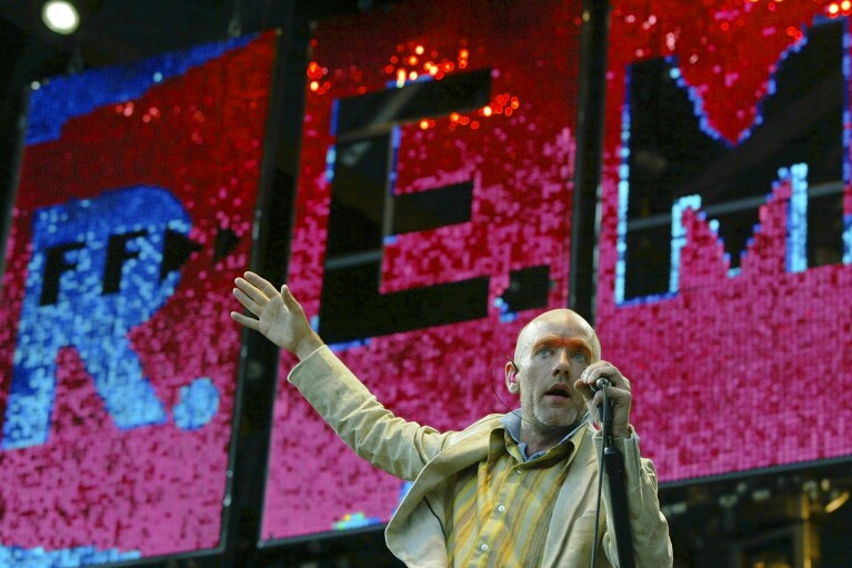 FILE - Michael Stipe, of the band R.E.M., sings during their concert in Hamburg's Volkspark, northern Germany, on July 1, 2003. Twenty-five years ago, R.E.M. released “Up,” the band's 11th album. (AP Photo/Christof Stache, File)