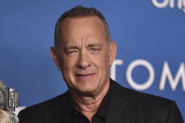 FILE - Tom Hanks arrives at the premiere of "Finch" on Tuesday, Nov. 2, 2021, at the Pacific Design Center in West Hollywood, Calif. Hanks will help launch a new era of Cleveland baseball. The Oscar-winning actor will throw out the ceremonial first pitch before the Guardians' home opener against the San Francisco Giants on April 15, 2022. (Photo by Richard Shotwell/invision/AP, File)