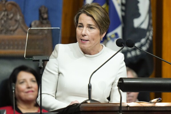 FILE - Massachusetts Gov. Maura Healey delivers her inaugural address in the House Chamber at the Statehouse moments after being sworn into office during inauguration ceremonies, Jan. 5, 2023, in Boston. Massachusetts is teaming with federal officials to help migrants in the state apply for work authorization permits. Healey has urged Biden administration officials to streamline access to the permits, saying they’re key to helping migrants find a job and leave the state’s overburdened shelter system. (AP Photo/Steven Senne, File)