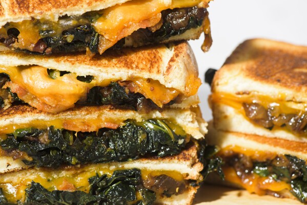 This image released by Milk Street shows a recipe for kale and cheddar melts. (Milk Street via AP)